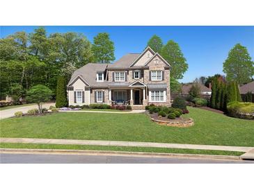 Charming two-story home with manicured lawn, stone accents, and a welcoming front porch at 2358 New Salem Trce, Marietta, GA 30064