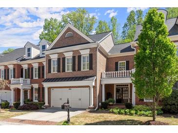 Charming brick townhome with a two-car garage and a beautifully landscaped front yard in a desirable community at 12150 Dancliff Trce, Alpharetta, GA 30009