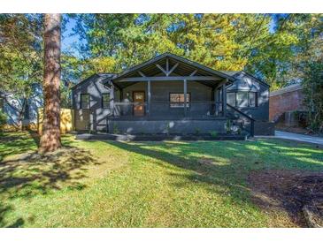 Charming home with a covered front porch, landscaped yard and fresh exterior paint at 1705 Ezra Church Nw Dr, Atlanta, GA 30314