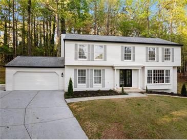 Charming two-story home featuring a freshly painted white exterior, black trim, and a well-maintained front yard at 220 Hobnail Se Ct, Marietta, GA 30067