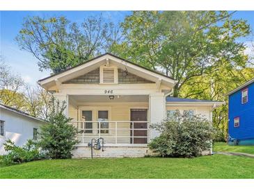 Charming single-story home featuring a quaint front porch and well-maintained lawn at 946 Crew Sw St, Atlanta, GA 30315