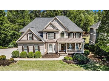 Charming two-story home with manicured landscaping and a welcoming front porch at 629 Gold Valley Pass, Canton, GA 30114