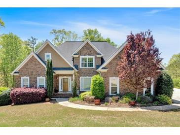 Charming brick home with a manicured lawn and inviting curb appeal at 7801 Windswept Way, Douglasville, GA 30135