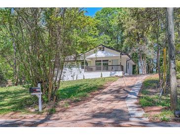 Charming one-story home with a well-manicured front yard and a welcoming front porch at 1679 Hollyhock Ter, Decatur, GA 30032