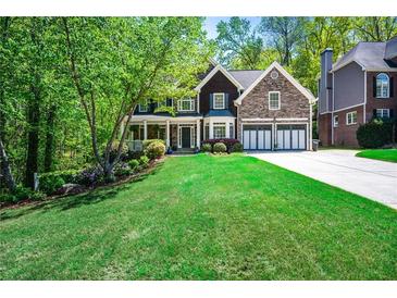 Charming home with a manicured lawn, stone accents, and a welcoming front porch at 1326 Benbrooke Nw Ln, Acworth, GA 30101