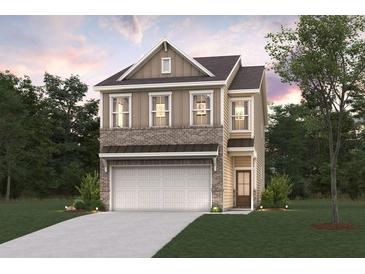 Charming two-story home featuring a brick and siding exterior, two-car garage, and well-manicured lawn at 1028 Sutherland Lane (Lot 45), Lawrenceville, GA 30043