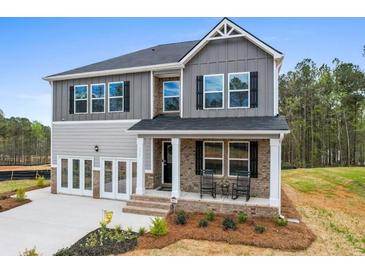 Charming two-story home with brick accents, covered porch, and well-maintained landscaping at 734 Great Oak Pl, Villa Rica, GA 30180