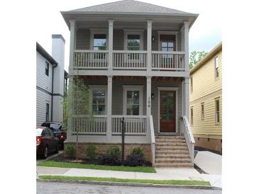 Charming two-story home with a welcoming front porch and a well-maintained landscaped yard at 106 Hogue St, Atlanta, GA 30312