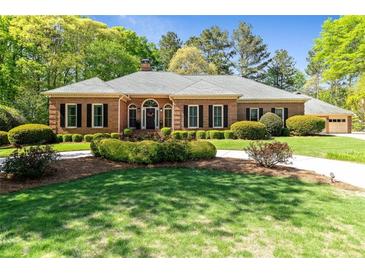 Charming single-story brick home featuring a landscaped yard and a welcoming front entrance at 8518 Shoreview Ct, Jonesboro, GA 30236