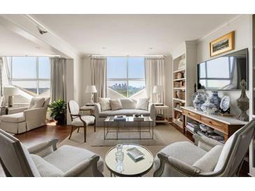 Bright living room featuring hardwood floors, city views, and elegant decor with plush seating at 2479 Peachtree Ne Rd # 1805, Atlanta, GA 30305