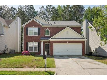 Charming two-story brick home with a well-manicured front yard and a two-car garage at 415 Clairidge Sw Ln, Lawrenceville, GA 30046