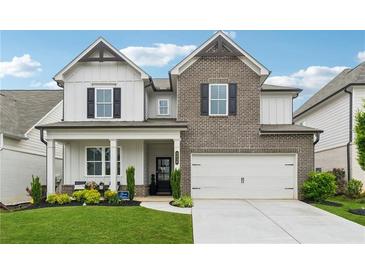 Charming two-story home featuring a brick facade, a well-maintained lawn, and a two-car garage at 3638 Silvery Way, Powder Springs, GA 30127