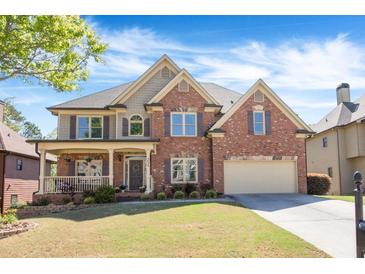 Charming two-story brick home with a well-manicured lawn and inviting front porch at 3634 Lost Oak Drive, Buford, GA 30519