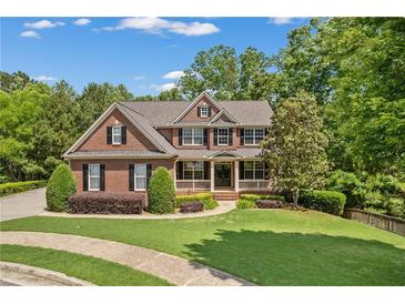 Beautiful two-story brick home with manicured lawn and charming front porch at 150 Fitzroy Ln, Acworth, GA 30101