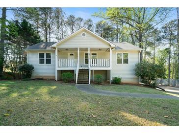 Charming single-story home with a welcoming front porch and a well-maintained lawn at 34 Cedar Creek Ct, Acworth, GA 30101