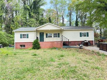 Cozy, single-story home featuring a well-manicured lawn and charming curb appeal at 1794 Blossom Ln, Austell, GA 30168