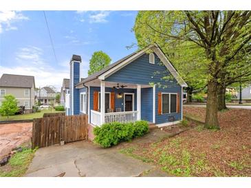 Charming blue cottage with a welcoming front porch and white railing at 650 Ira Sw St, Atlanta, GA 30312
