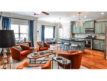 Open-concept living area with colorful decor and modern kitchen featuring a breakfast bar and updated appliances at 2250 W Village Junction Se Way, Smyrna, GA 30080