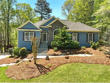 Charming home with stone accents and a beautifully landscaped front yard at 3015 Larkspur Ct, Cumming, GA 30041