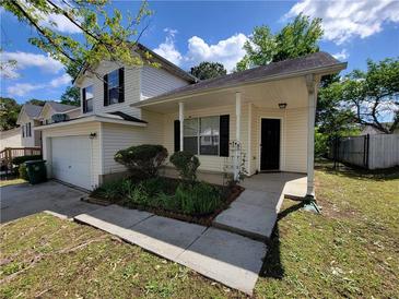 Two-story home with a garage and a well-maintained front yard on a sunny day at 5820 Wellborn Oaks Ct, Lithonia, GA 30058