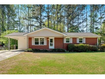 Charming brick ranch-style home featuring a carport and a well-maintained lawn at 3393 Ridgecrest Dr, Powder Springs, GA 30127