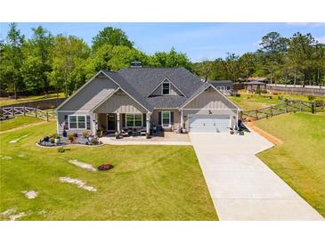 Charming single Gathering home boasts a long driveway and well-manicured lawn at 7001 Palomino Trl, Winston, GA 30187