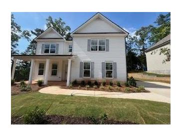 Charming two-story home featuring white siding, gray shutters and a beautifully landscaped front yard at 4517 Ajo Walk, Atlanta, GA 30331