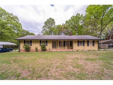 Charming single-story home featuring a cozy front porch and well-manicured lawn at 284 Zion Wood Rd, Loganville, GA 30052