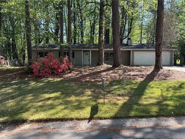 Charming single-story home with flowering shrubs and a two-car garage at 3347 Sir Lancelot Sw Pl, Marietta, GA 30008