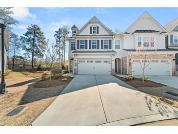Charming two-story home with symmetrical facade, double garage, driveway and manicured lawn in a suburban neighborhood at 1041 Cherryfield Run, Marietta, GA 30008
