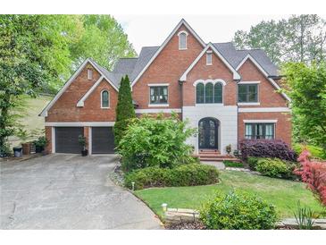 Beautiful brick home featuring an attached two-car garage and a meticulously landscaped front yard at 4730 W Forest Peak, Marietta, GA 30066