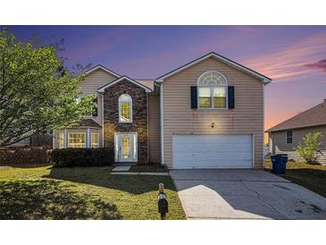 Charming two-story home with a well-manicured lawn and a two car garage at 3243 Timber Rdg, College Park, GA 30349