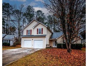 Charming two-story home with a two-car garage and well-maintained landscaping at 3371 Metro Way, Snellville, GA 30039