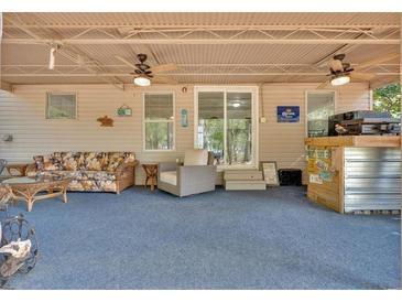 Spacious covered patio with ceiling fans, comfortable seating, and a bar area for entertaining at 5400 Kings Camp Cabin 16 Se Rd, Acworth, GA 30102