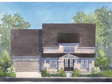 Charming two-story home featuring a stone facade, covered entry, and attached garage at 5235 Memento Trace, Cumming, GA 30040