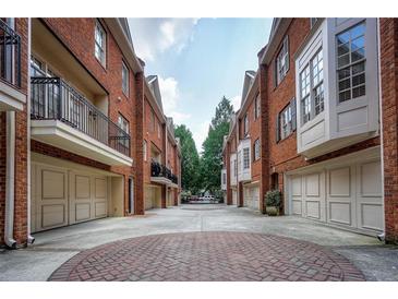 Charming brick townhomes with private garages and a brick courtyard create a desirable neighborhood setting at 774 Piedmont Ne Ave # 11B, Atlanta, GA 30308
