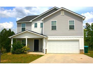 Charming two-story home featuring a gray exterior, attached garage, and well-maintained front yard at 23 Oxford Ln, Kingston, GA 30145