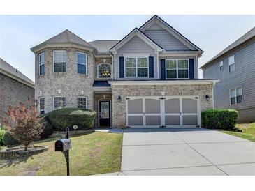 Charming two-story brick home with a well-manicured lawn and attached two-car garage at 5976 Princeton Run Trl, Tucker, GA 30084