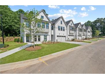 Charming exterior view of townhomes with manicured lawns and inviting curb appeal at 114 Briargate Dr, Johns Creek, GA 30097