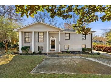 Charming gray brick home with large front windows and landscaped yard, creating an inviting curb appeal at 1393 Cerro Vista Dr, Atlanta, GA 30316