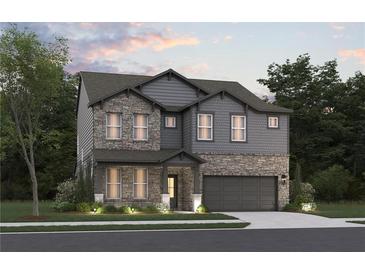 Charming two-story home featuring stone accents, gray siding, manicured landscaping, and an attached two-car garage at 7630 Homer Dr, Cumming, GA 30028