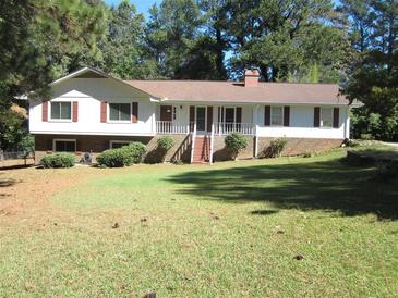 Charming single-Gathering home with well-maintained front lawn, mature trees, and inviting facade at 2107 Briarwood Ct, Snellville, GA 30078