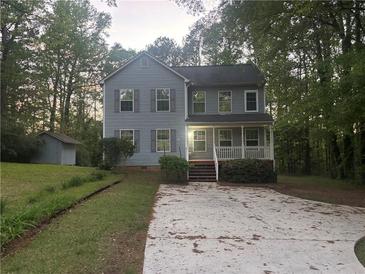 Charming two-story home with a welcoming front porch, neat landscaping, and a spacious front yard at 691 Aberdeen Dr, Stone Mountain, GA 30083