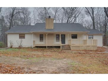 Charming single-story home with a welcoming front porch and neutral exterior paint at 5520 Hearn Rd, Ellenwood, GA 30294