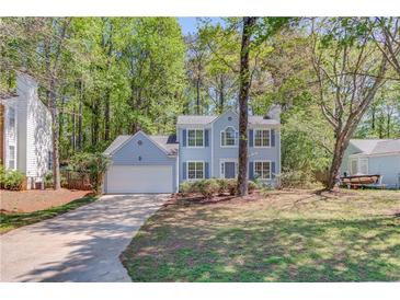 Charming two-story home featuring a well-maintained yard and a cozy, inviting facade at 11205 Abbotts Station Dr, Duluth, GA 30097