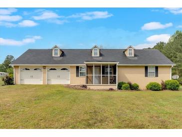 Charming home featuring a large front yard and a convenient two-car garage at 40 L Z Jackson Road, Bowdon, GA 30108