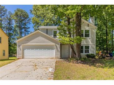 Charming two-story home with a two-car garage and mature trees in a suburban setting at 5439 Farmview Close, Stone Mountain, GA 30088