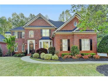 Stunning brick home featuring manicured landscaping and a classic architectural design at 125 Stoney Ridge Dr, Alpharetta, GA 30022