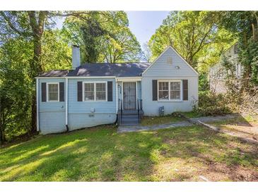 Charming light blue house with black shutters and a well-maintained front yard and mature trees in a quiet neighborhood at 1328 Lockhaven Sw Cir, Atlanta, GA 30311