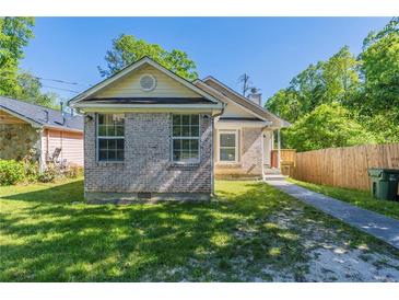 Charming brick home featuring a well-maintained lawn and inviting front entrance at 2212 Butner Sw Rd, Atlanta, GA 30331